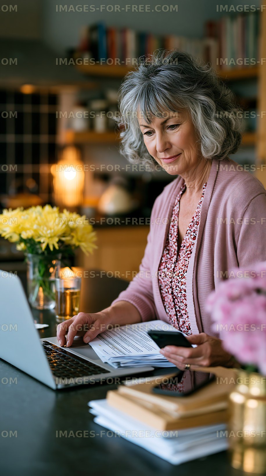 Woman working on laptop at home office table