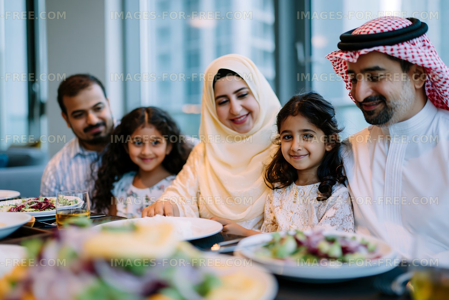Family enjoying a meal together in a modern dining setting
