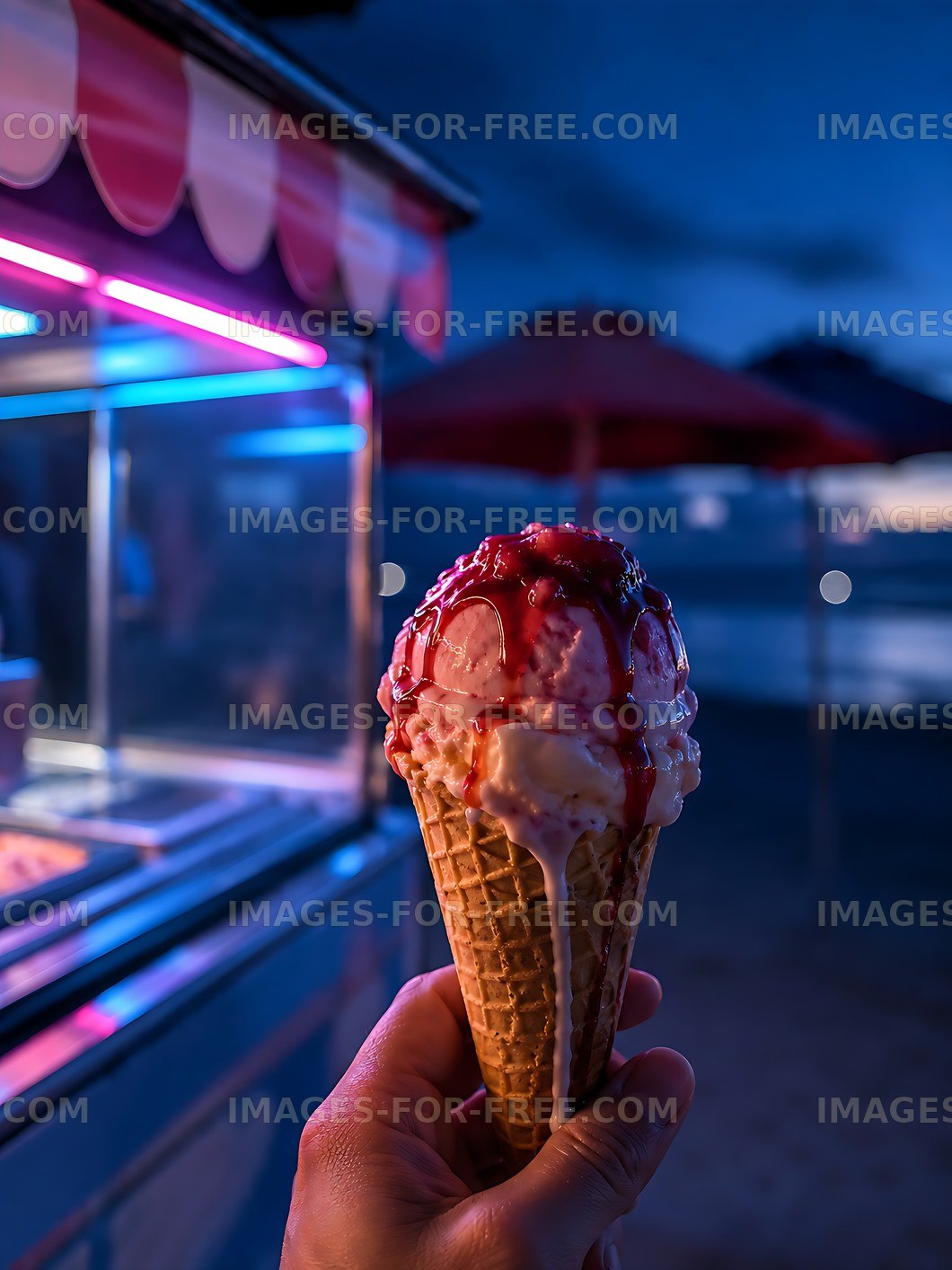 Ice cream cone with syrup at a beach stand in evening light