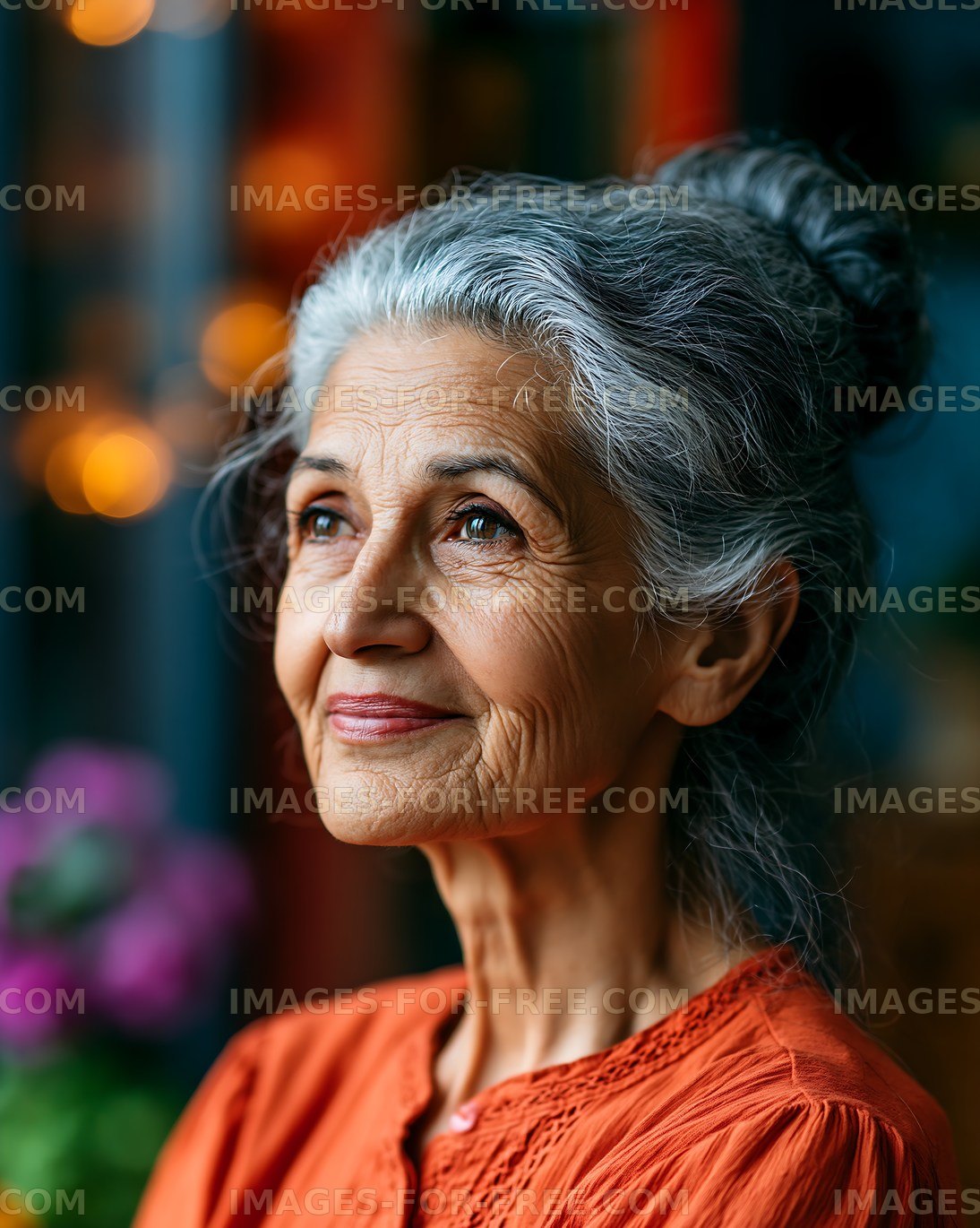 Elderly woman with gray hair looking thoughtfully outdoors