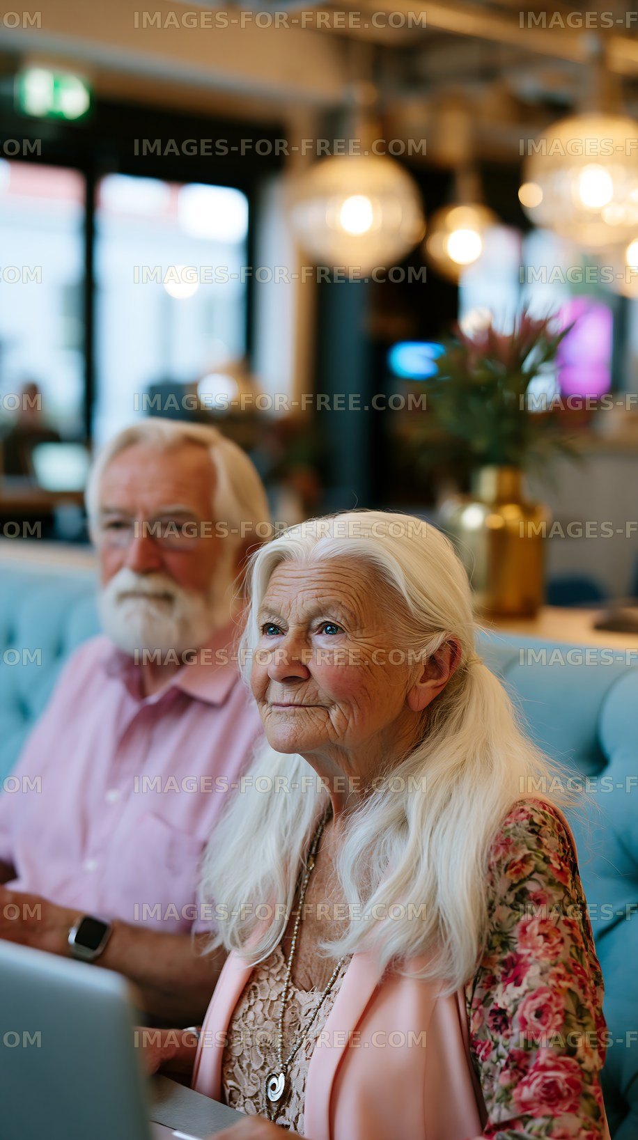 Elderly couple enjoying coffee in a modern cafe