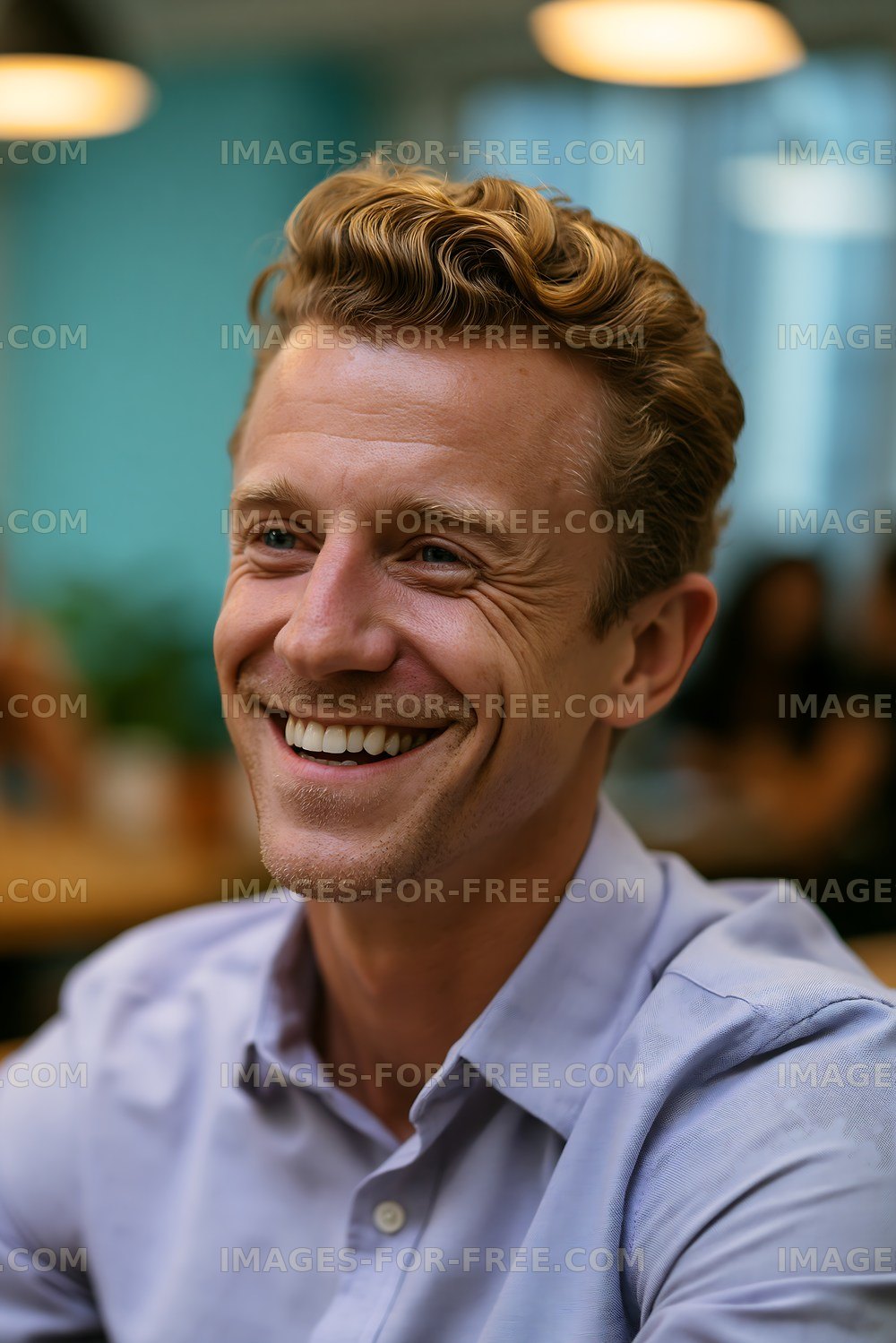 Smiling man with curly hair sitting in a café
