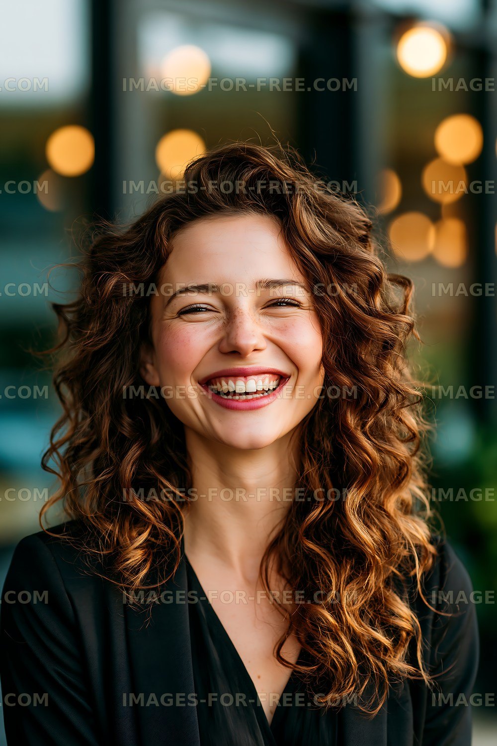 Woman smiling in a cafe with warm lights in the background