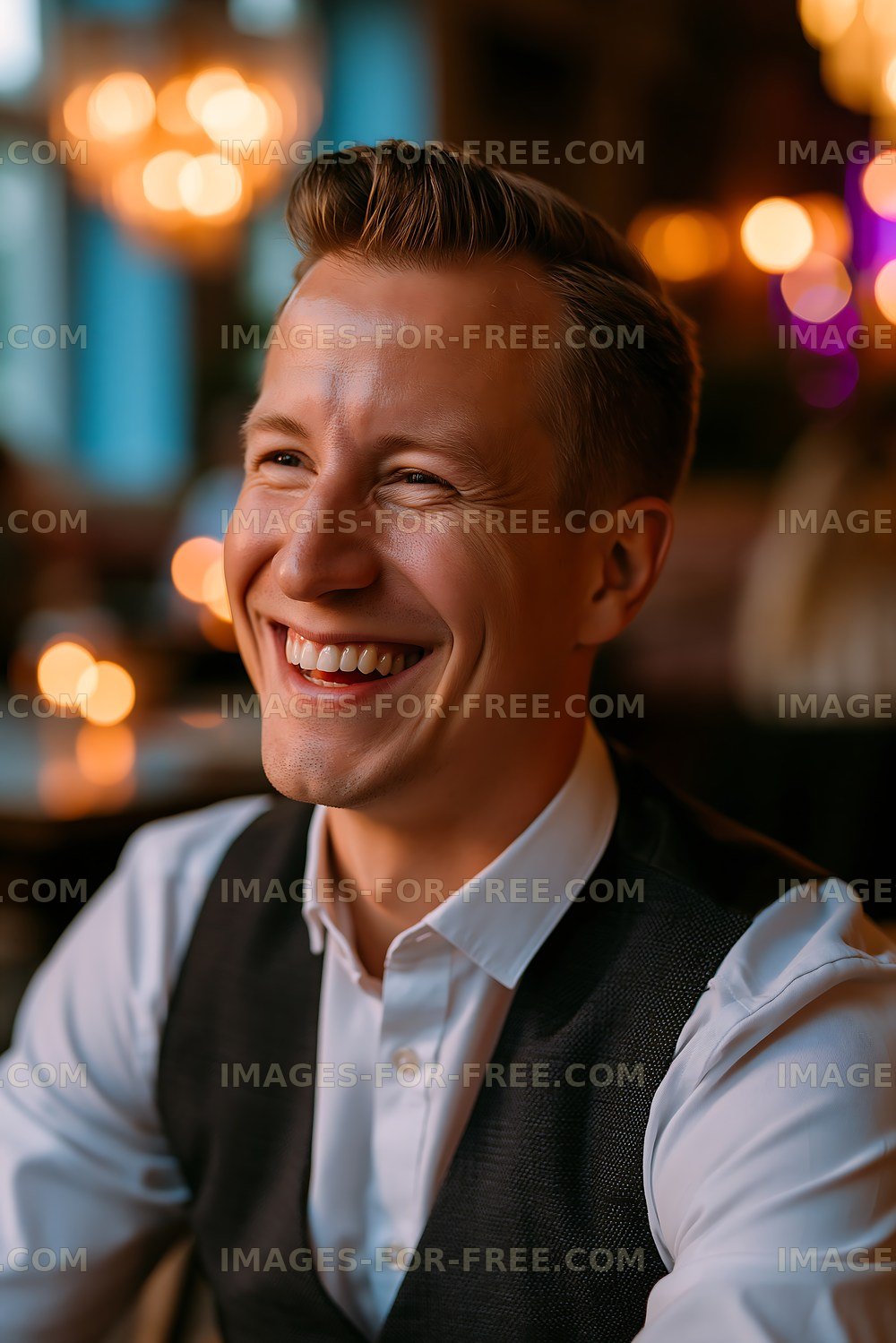 Man smiling in casual setting with warm lights