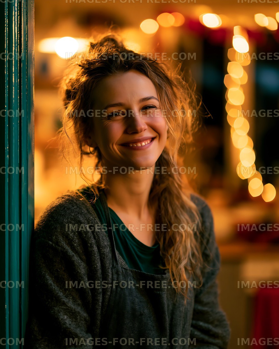 Smiling woman in cozy setting with warm lights