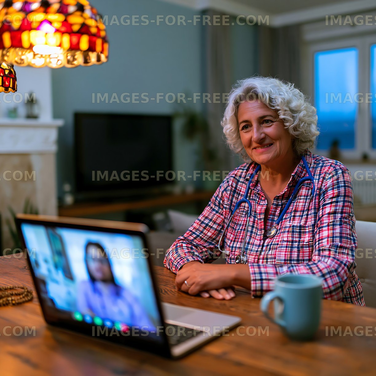 Elderly woman enjoys video call at home during evening