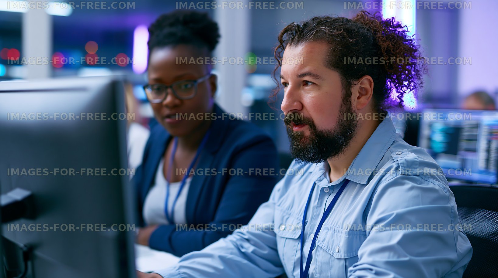 Team members working on computer in modern office environment