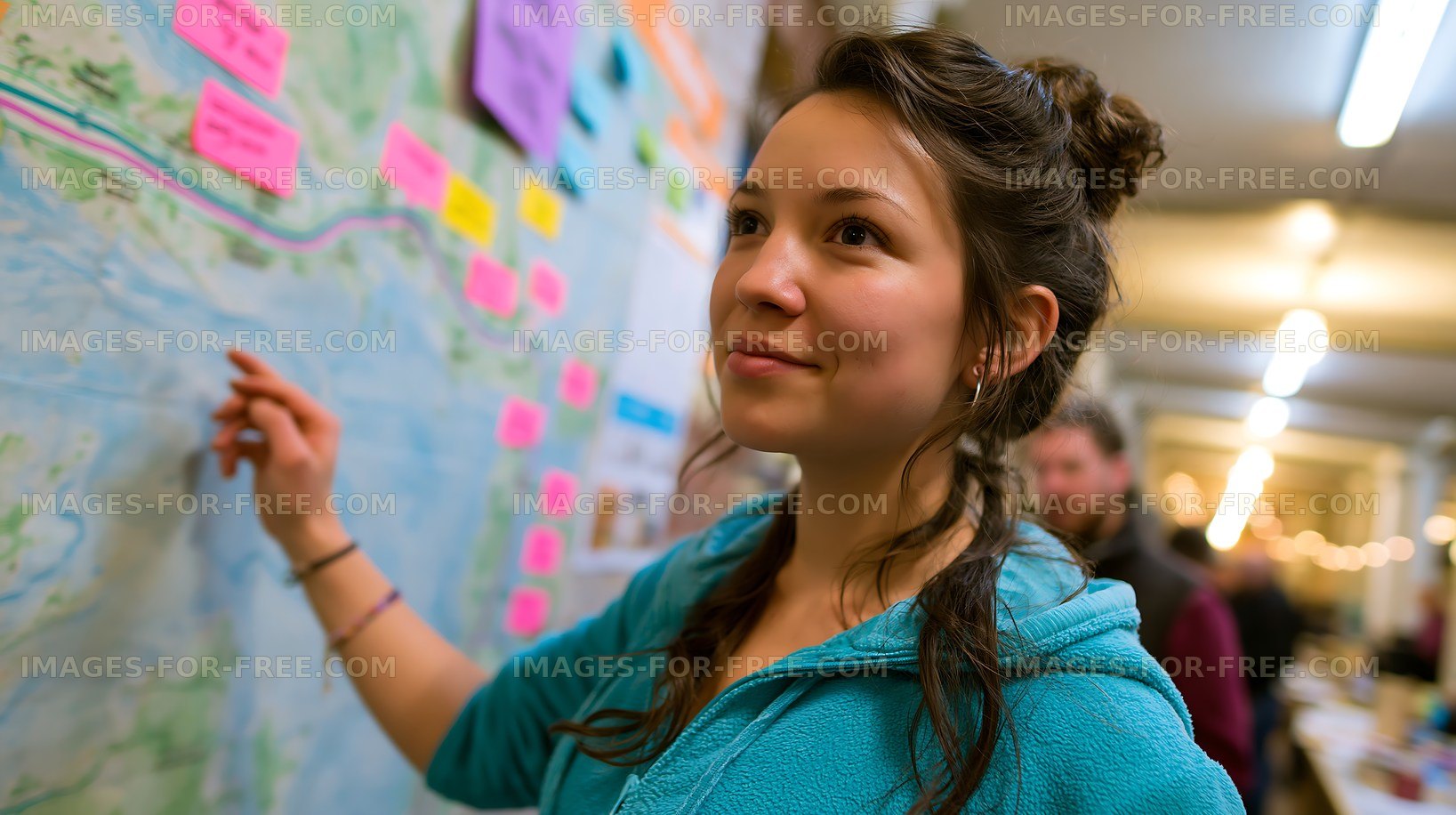 Young woman engages with a map at a community event