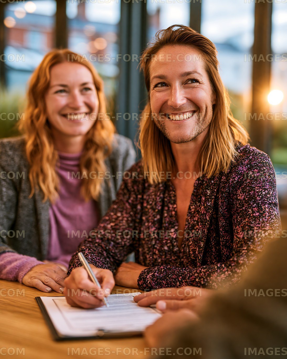 People signing documents in modern cafe setting