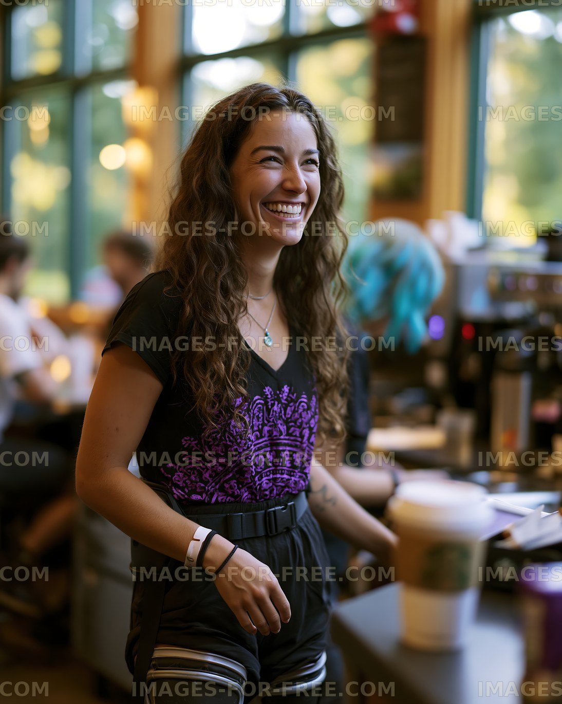 Barista smiling while working in a busy café environment