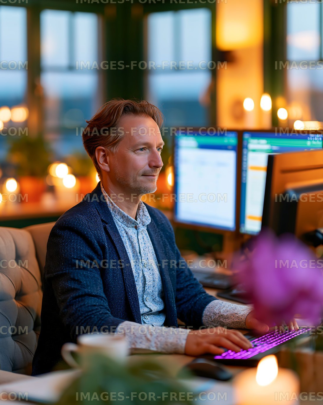 Man working on computer in cozy office during evening hours