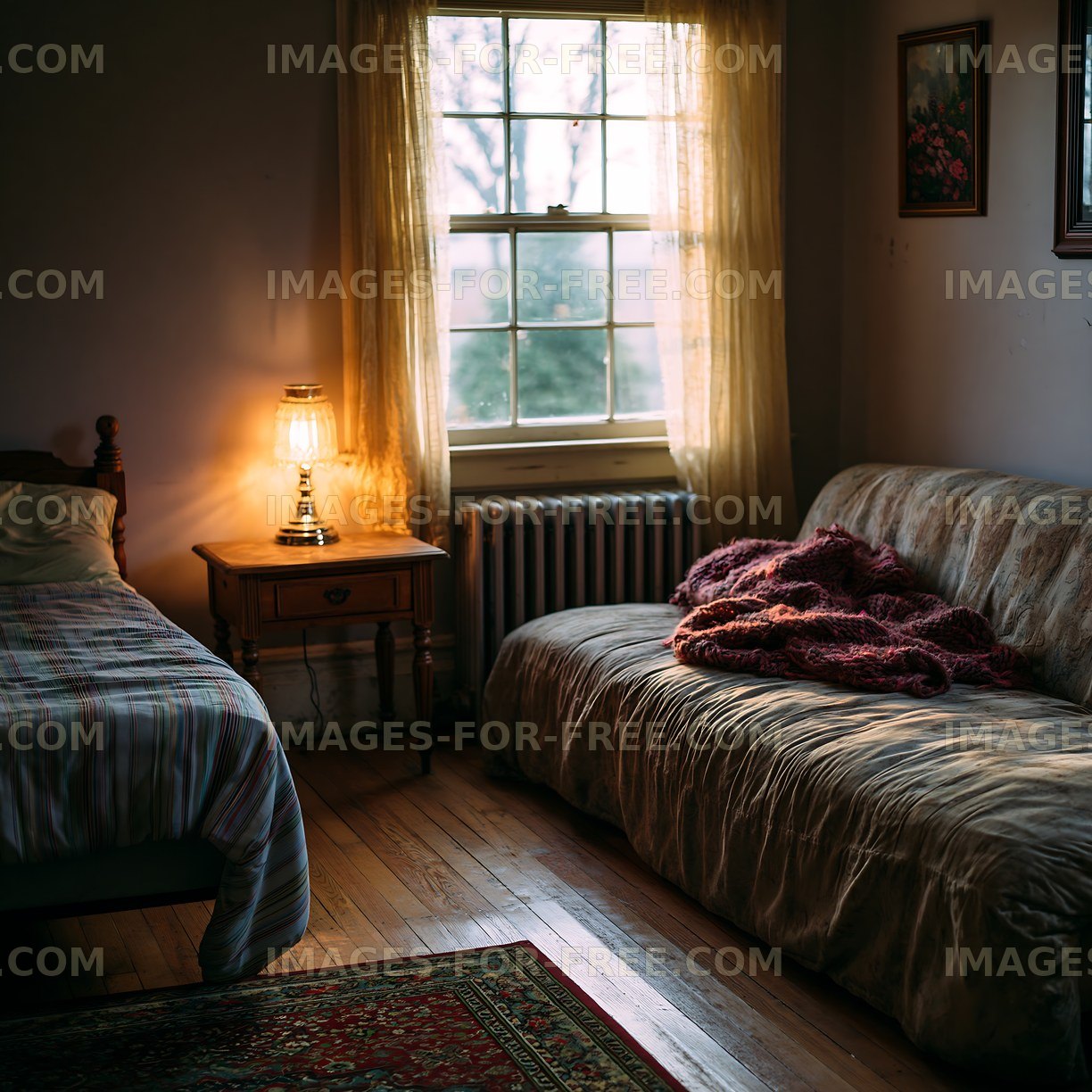 Cozy room with a bed and a sofa during evening light