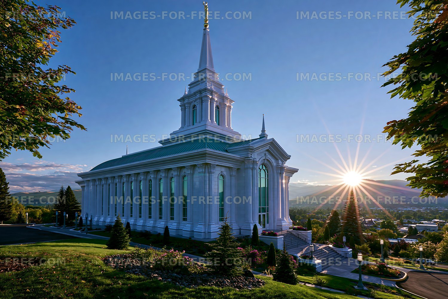 Sunrise at a temple with trees and mountains in the background