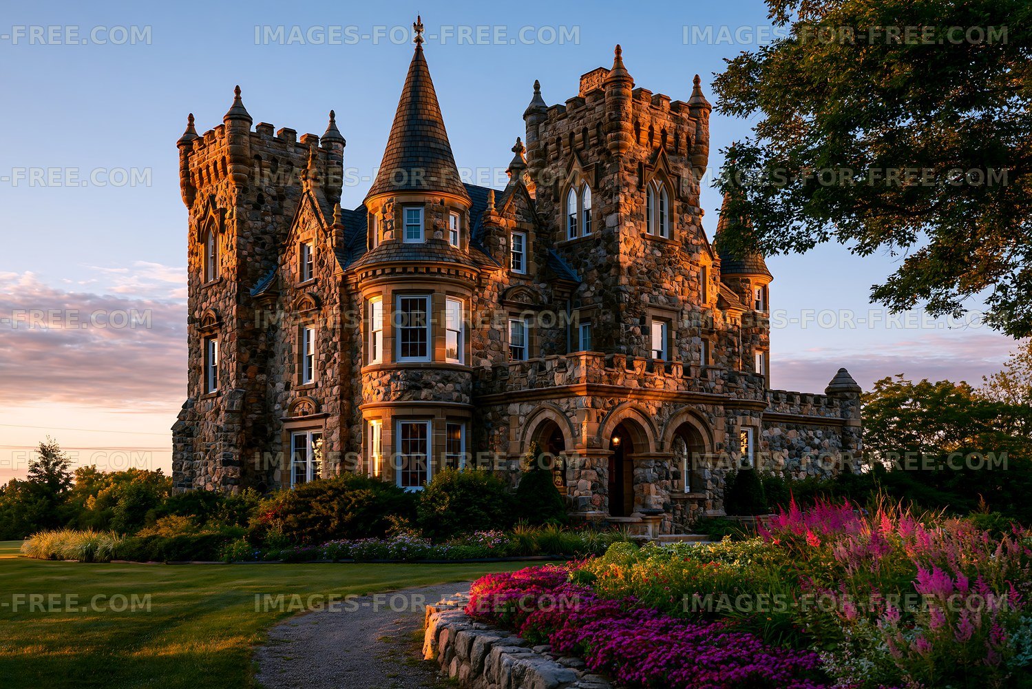Stunning stone castle with turrets and gardens at sunset