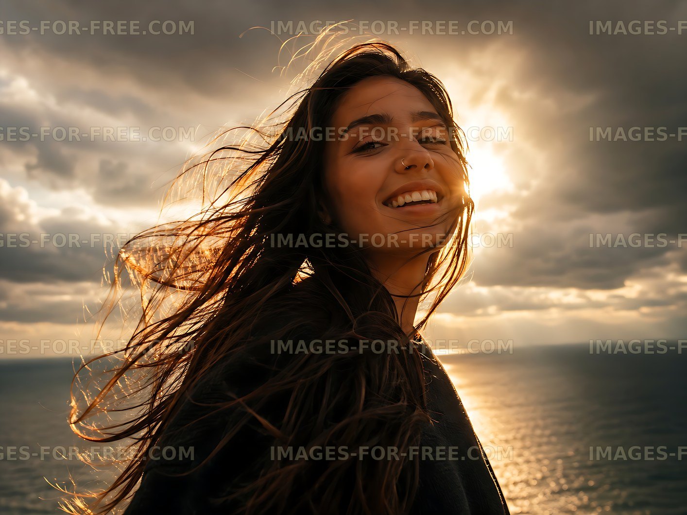 Woman standing near ocean with sunset in background