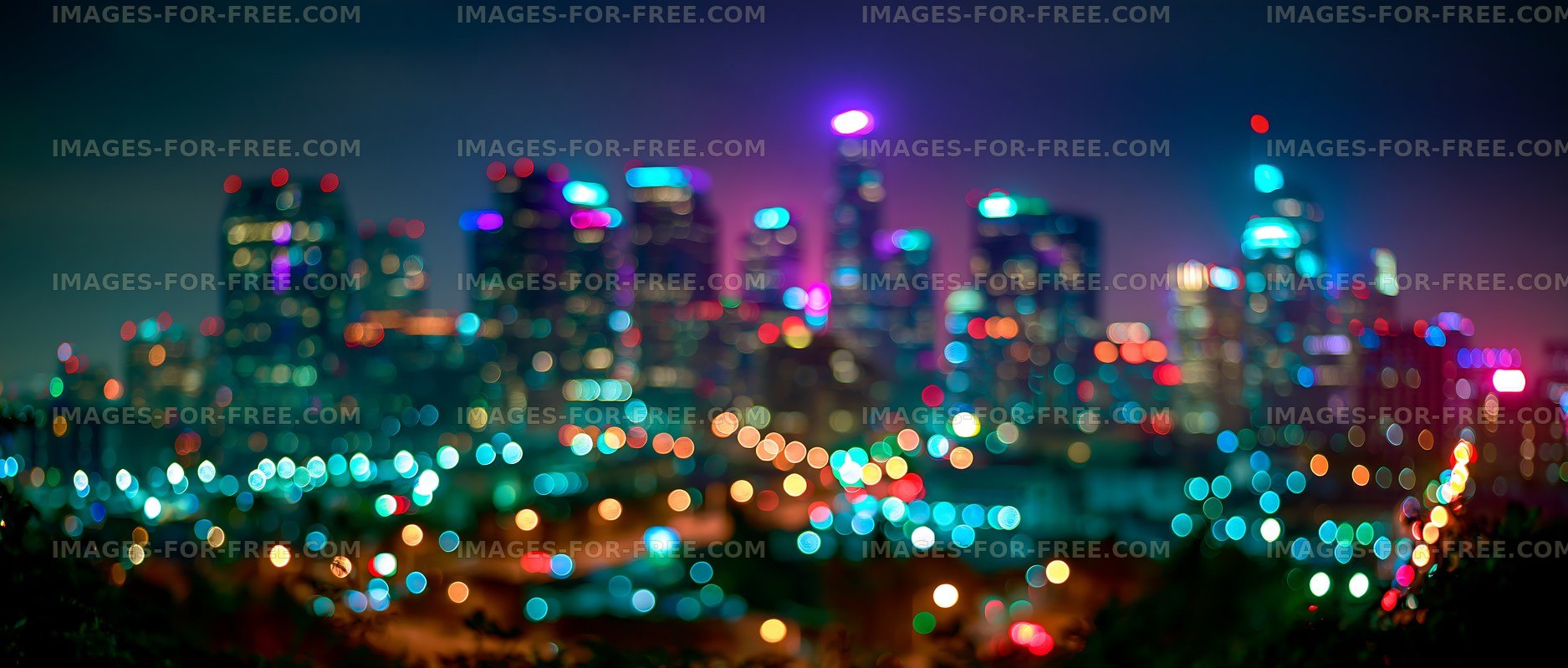 City skyline at night with colorful bokeh lights