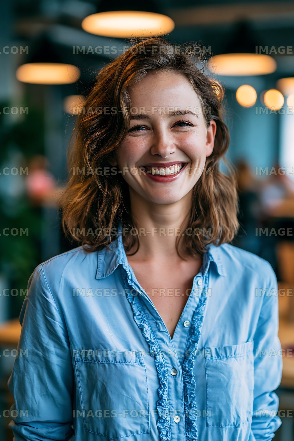 Smiling woman in blue shirt at modern cafe