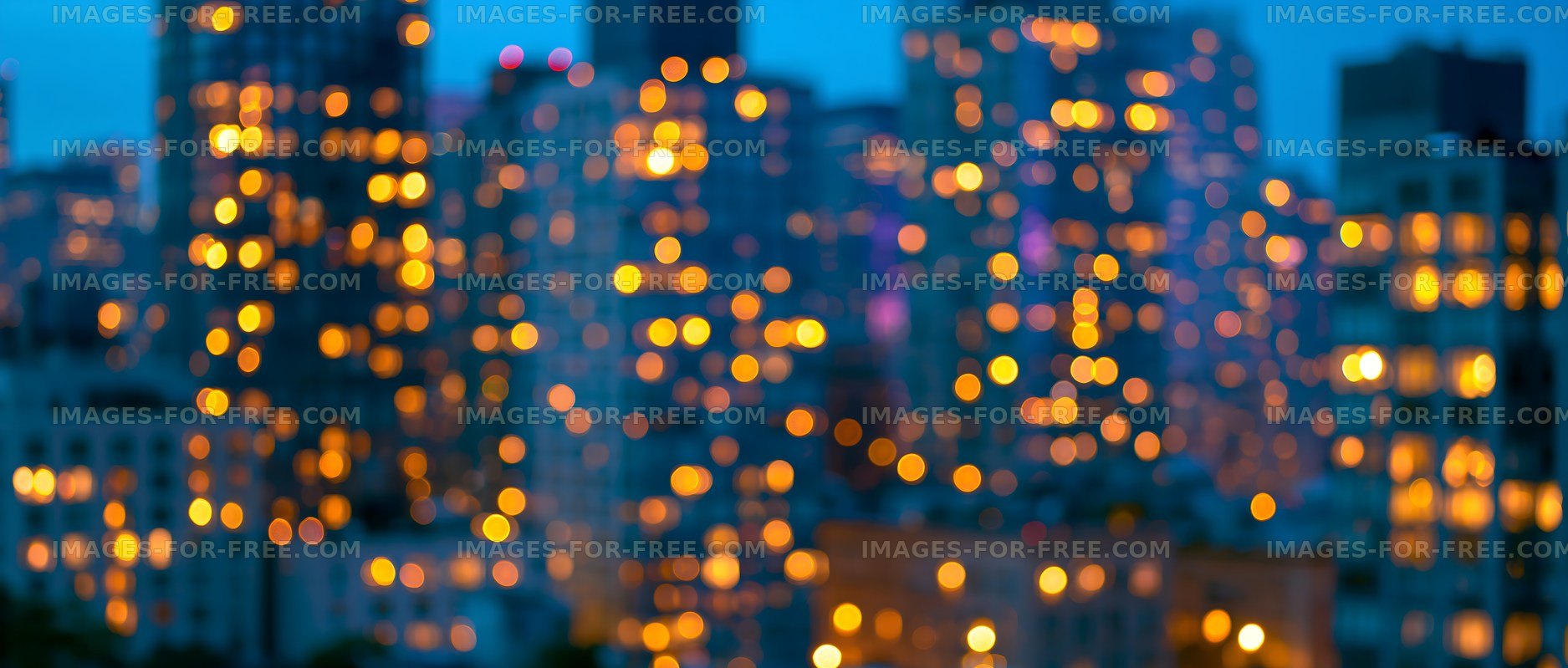 City skyline at dusk with blurred lights shining