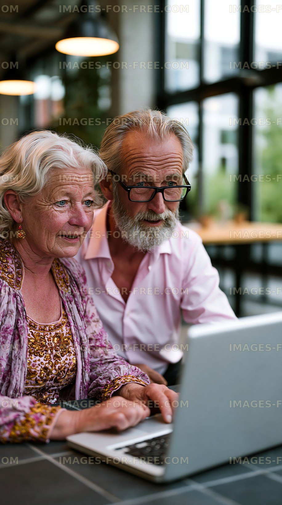 Seniors enjoying technology together in a modern workspace