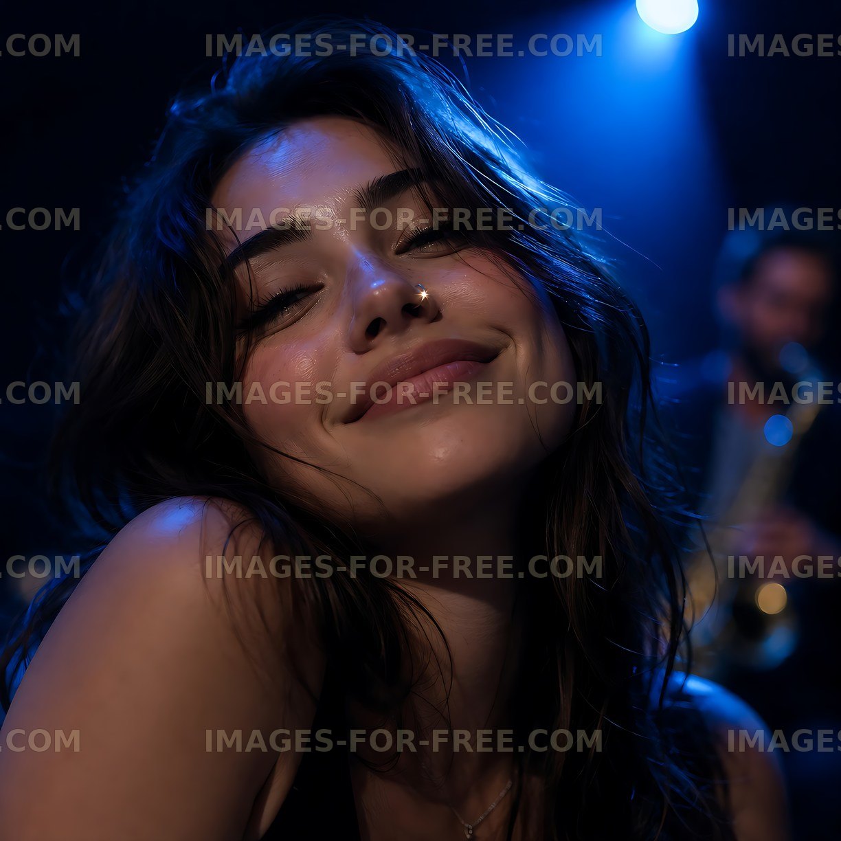 Woman smiling in a dimly lit music venue with blue lights