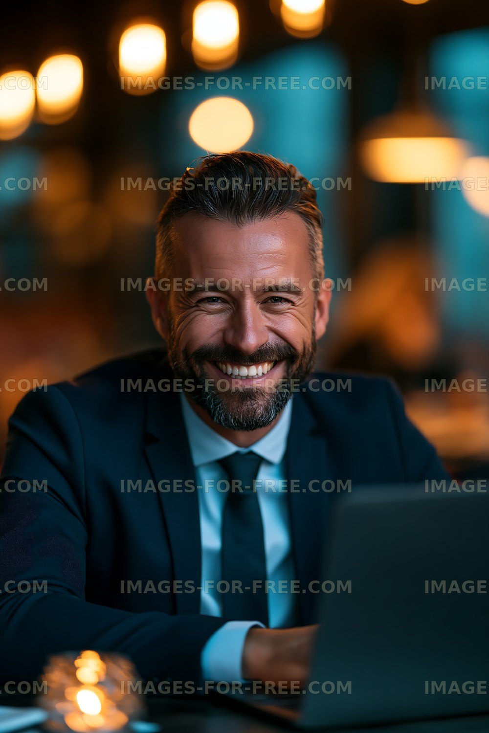 Businessman smiling in a cafe during evening hours