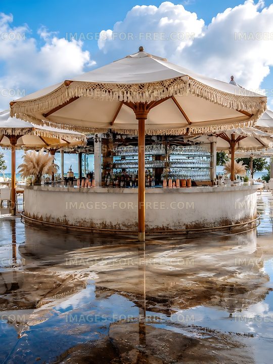 Outdoor bar under a canopy with reflections on wet surface