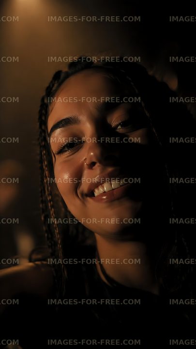Smiling woman in warm light at indoor nighttime event