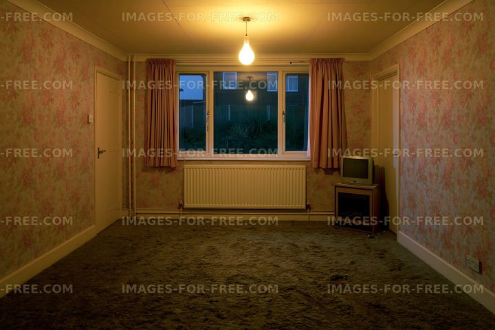 Empty room with a window and a single light source