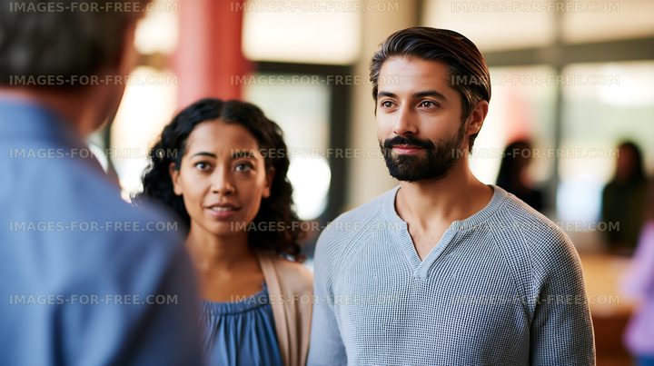 Group of people in conversation at a sunny indoor event
