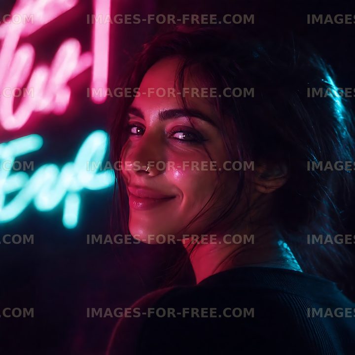 Woman smiling near neon signs at night