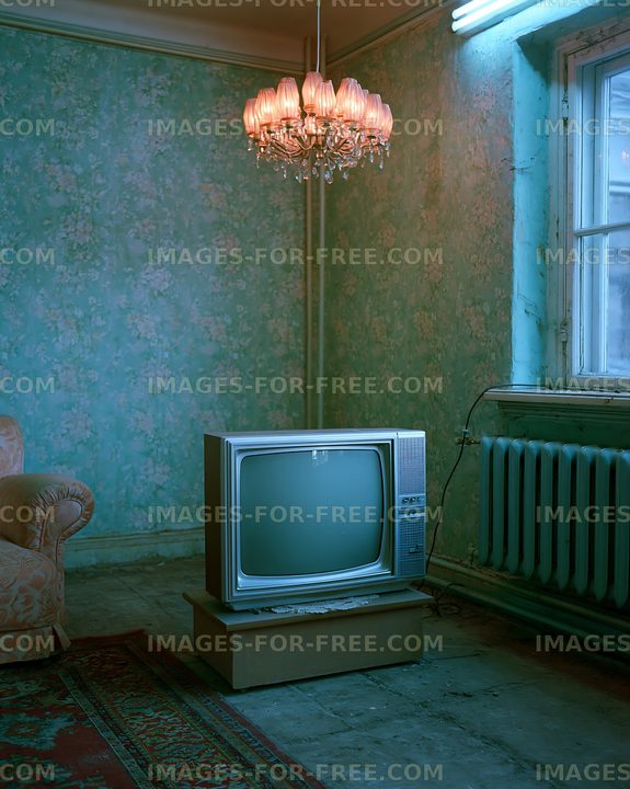Vintage television in a retro room with a chandelier