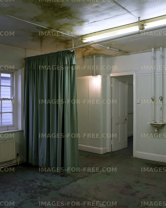 Empty room with green curtain and visible water damage