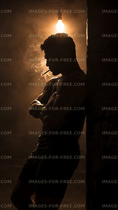 Silhouette of a man smoking in a dimly lit room