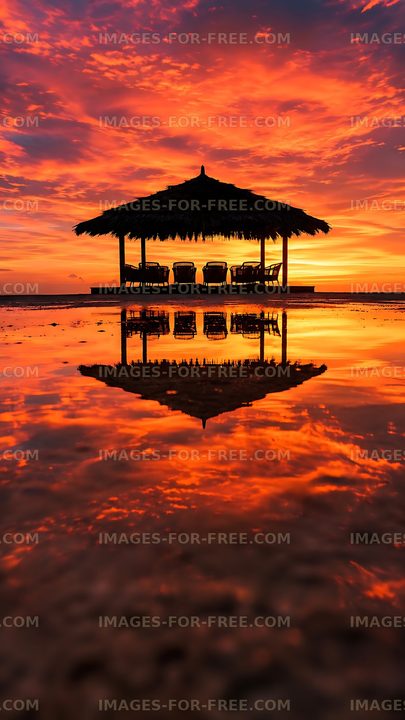 Sunset at a beach hut with reflections on the water