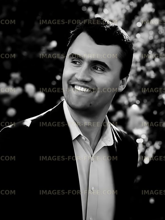 Man smiling outdoors with blurred floral background